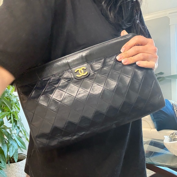 CHANEL Handbags - CHANEL Black Vintage Quilted Clutch with Gold 24k Logo